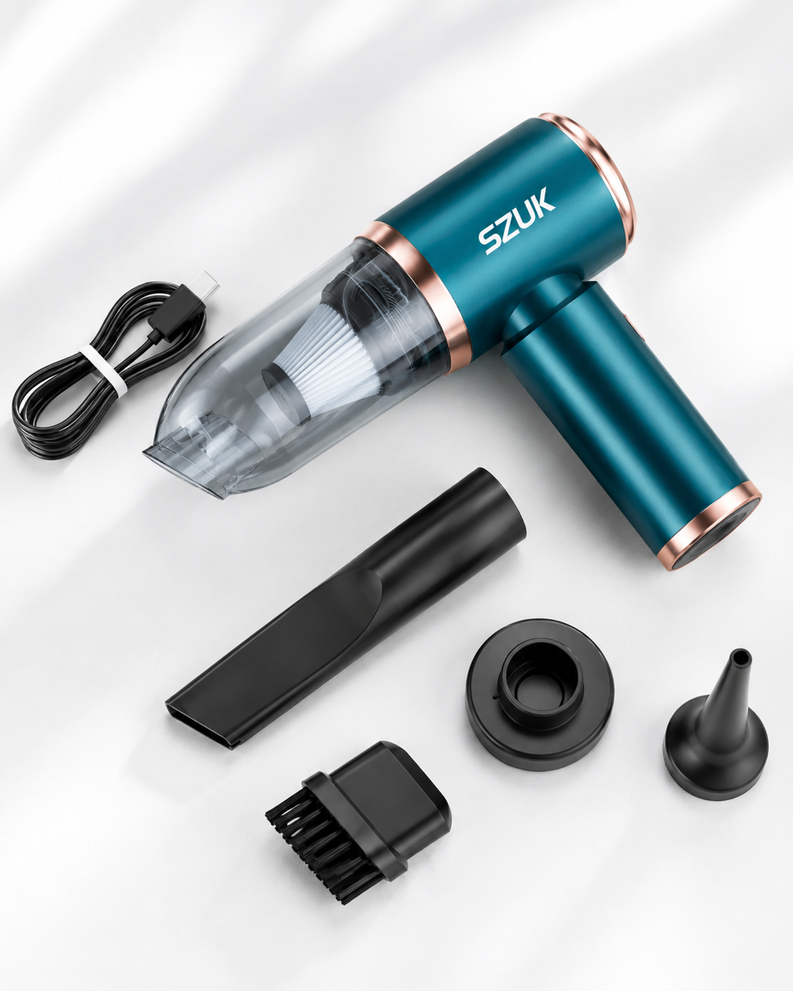 Detail of the vacuum laid out with its charging cable, crevice tool, brush and nozzle attachments